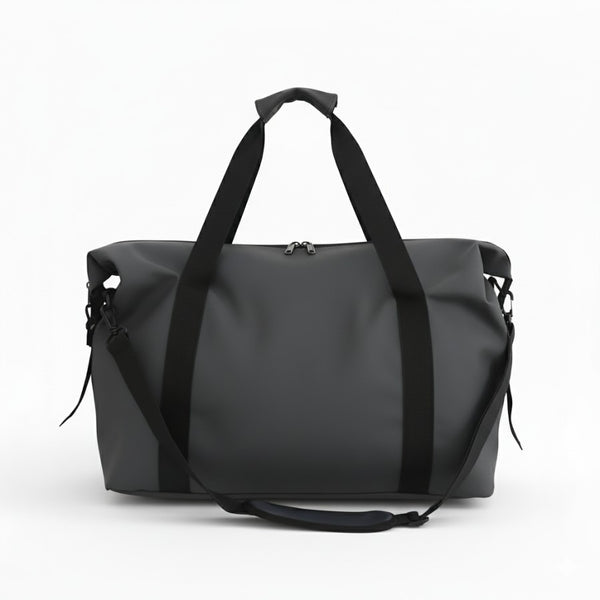 Sac fourre tout de voyage gris vu de face, grand compartiment central zippé et poignées renforcées.