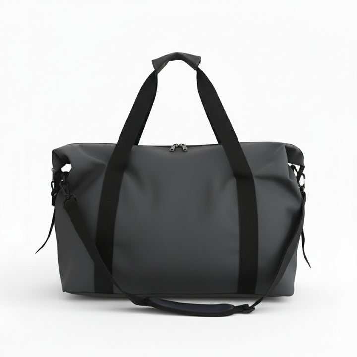 Sac fourre tout de voyage gris vu de face, grand compartiment central zippé et poignées renforcées.